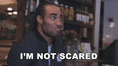 Man Saying I'm Not Scared In Front Of Shelf Full Of Bottles GIF