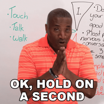 Man Saying Ok Hold On A Second In Front Of Whiteboard GIF