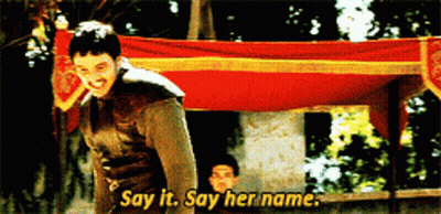 Man Saying Say It Say Her Name In Front Of Banner GIF