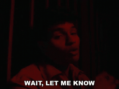 Man Saying Wait In Dark Room GIF