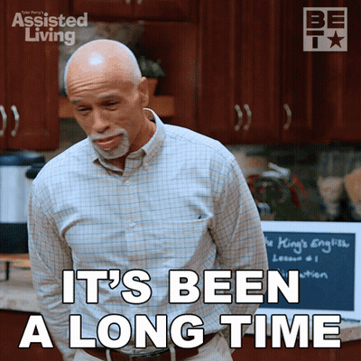 Man Says It's Been A Long Time In Front Of Chalkboard GIF