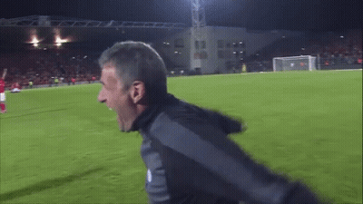 Man Screaming On Soccer Field In Front Of Building Saying AA GIF