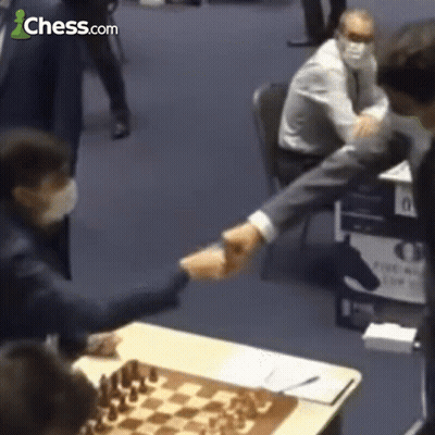 Man Shaking Hands In Front Of Chessboard GIF