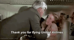 Man Shaking Panicking Lady In Flying Airplane GIF
