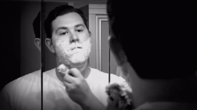 Man Shaving In Front Of Mirror GIF