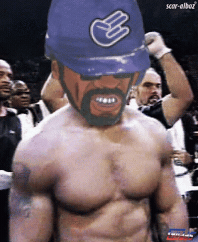 Man Shirtless Wearing Blue Hat With Hand Symbol GIF