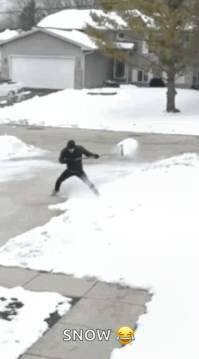 Man Shoveling Snow With Smiley Snow Sign GIF