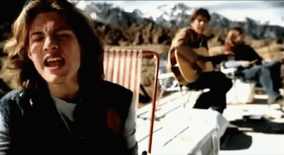 Man Singing And Playing Guitar Beside Seated Man GIF