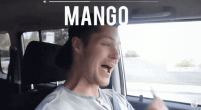 Man Singing In Car With Mango On Screen GIF