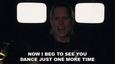 Man Singing In Front Of Two Televisions Saying Now I Beg To See You Dance Just One More Time GIF