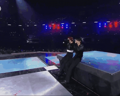 Man Singing In Red Jacket And Gold Necklace GIF