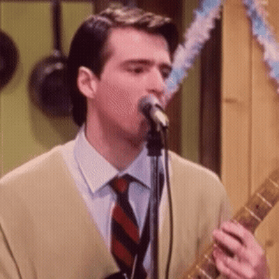 Man Singing Into Microphone And Playing Guitar GIF