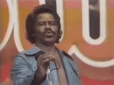 Man Singing Into Microphone At Sign Saying U GIF