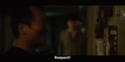 Man Singing Into Microphone Beside Screen With Blocks GIF