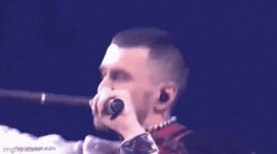 Man Singing Into Microphone Blue Background GIF