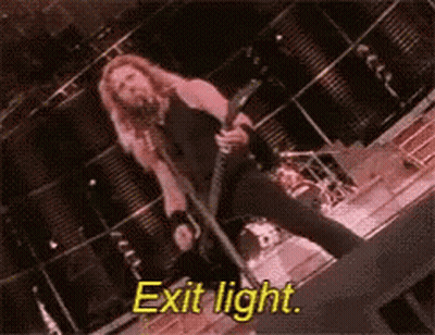 Man Singing Into Microphone Holding Guitar Exit Light GIF