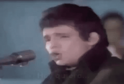 Man Singing Into Microphone Holding Guitar GIF