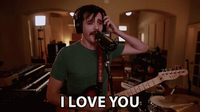 Man Singing Into Microphone Holding Guitar Saying I Love You GIF