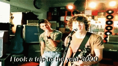 Man Singing Into Microphone I Took A Trip To The Year 3000 GIF