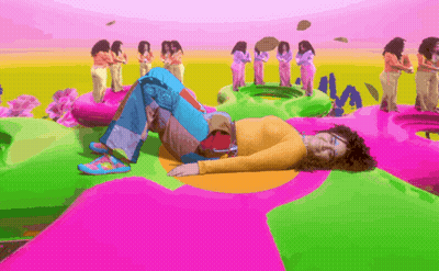Man Singing Into Microphone In Blue And Yellow Outfit GIF