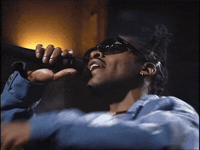 Man Singing Into Microphone In Blue Jacket GIF