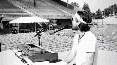 Man Singing Into Microphone In Empty Bleachers GIF