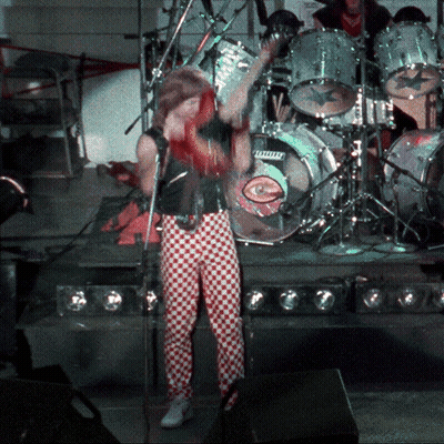 Man Singing Into Microphone In Front Of Ludwig Drum Set GIF