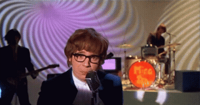 Man Singing Into Microphone In Front Of Mira Band GIF