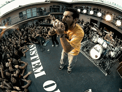 Man Singing Into Microphone In Front Of System Of O GIF