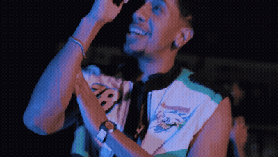 Man Singing Into Microphone In Manchester Shirt GIF