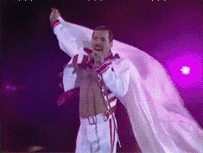 Man Singing Into Microphone In White Robe GIF