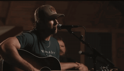 Man Singing Into Microphone In WRN & Ivy Shirt GIF