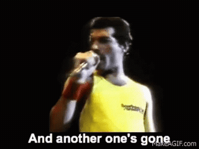 Man Singing Into Microphone In Yellow Shirt GIF
