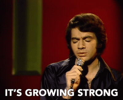 Man Singing Into Microphone It's Growing Strong GIF