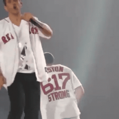 Man Singing Into Microphone Next To Man In 617 Shirt GIF