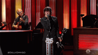 Man Singing Into Microphone Next To WSM Gran Sign GIF