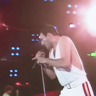 Man Singing Into Microphone On Stage GIF