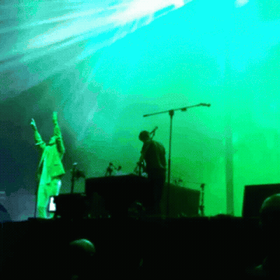 Man Singing Into Microphone On Stage GIF