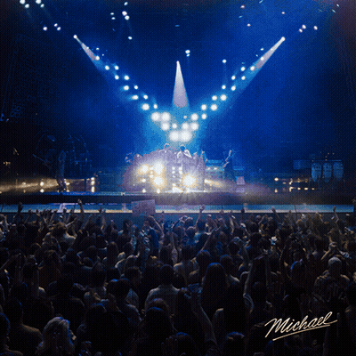 Man Singing Into Microphone On Stage Named Michael GIF