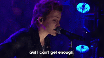 Man Singing Into Microphone On Stage GIF