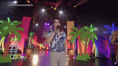 Man Singing Into Microphone On Stage With Palm Trees ASAP Summer GIF