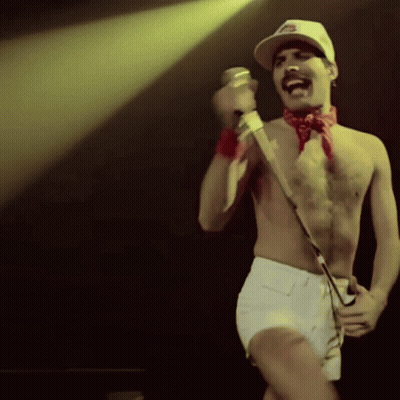 Man Singing Into Microphone On Stage GIF