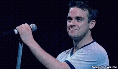Man Singing Into Microphone On Stage GIF