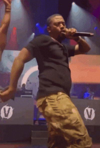 Man Singing Into Microphone On Stage GIF