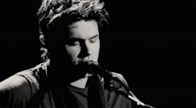 Man Singing Into Microphone Playing Guitar GIF