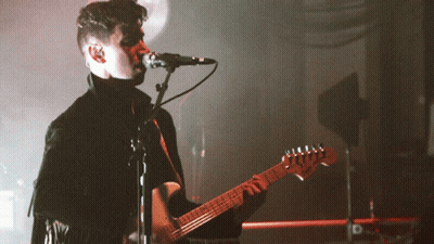 Man Singing Into Microphone Playing Guitar GIF