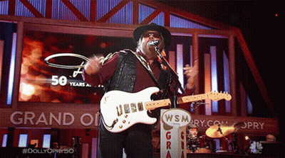 Man Singing Into Microphone Playing Guitar At Grand Ole Opry GIF