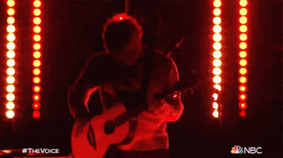 Man Singing Into Microphone Playing Guitar With NBC Logo GIF