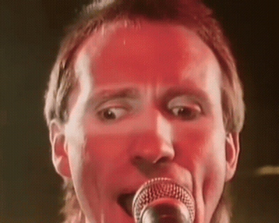 Man Singing Into Microphone Red Background GIF