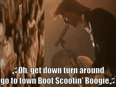 Man Singing Into Microphone Saying Oh Get Down Turn Around Go To Town Boot Scootin Boogie GIF